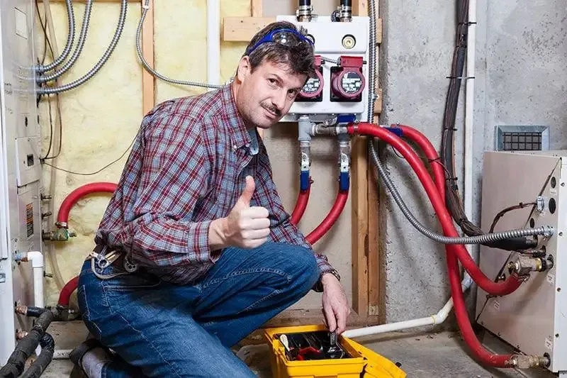 Technician after repairing an HVAC system in Fort Collins.