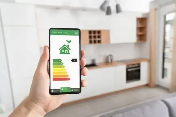 Smartphone displaying Smart Home Energy efficiency app categorized from A to G, within a modern residential house in Fort Collins.