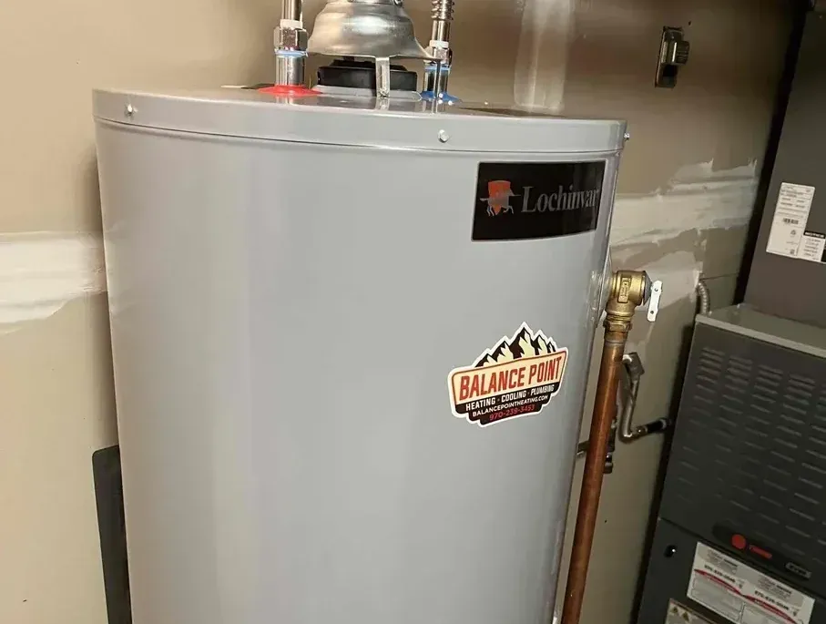 A newly installed Lochinvar gas tank-style water heater connected with clean copper piping and proper venting.