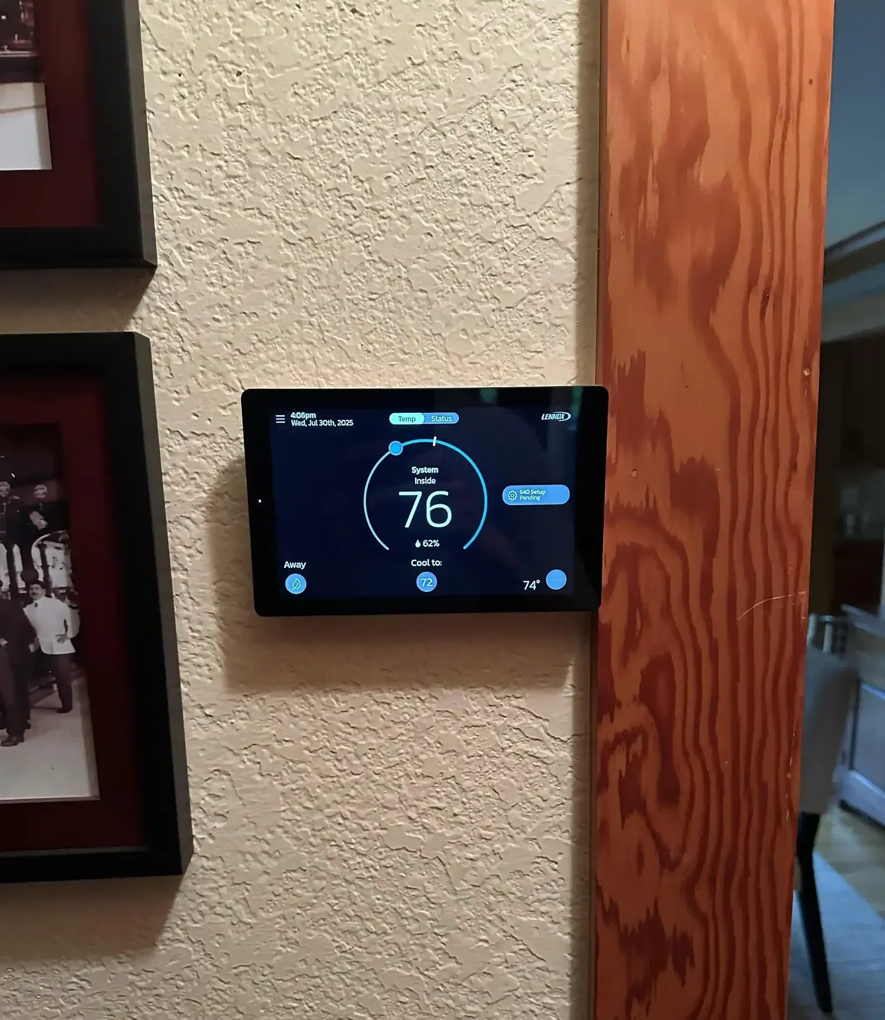 The wall-mounted Lennox S40 smart thermostat interface displaying system status during a new HVAC commissioning.