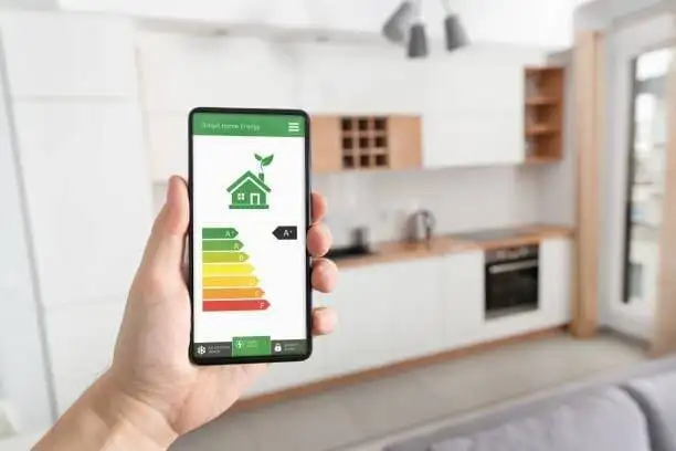 Smartphone displaying Smart Home Energy efficiency app categorized from A to G, within a modern residential house in Fort Collins.