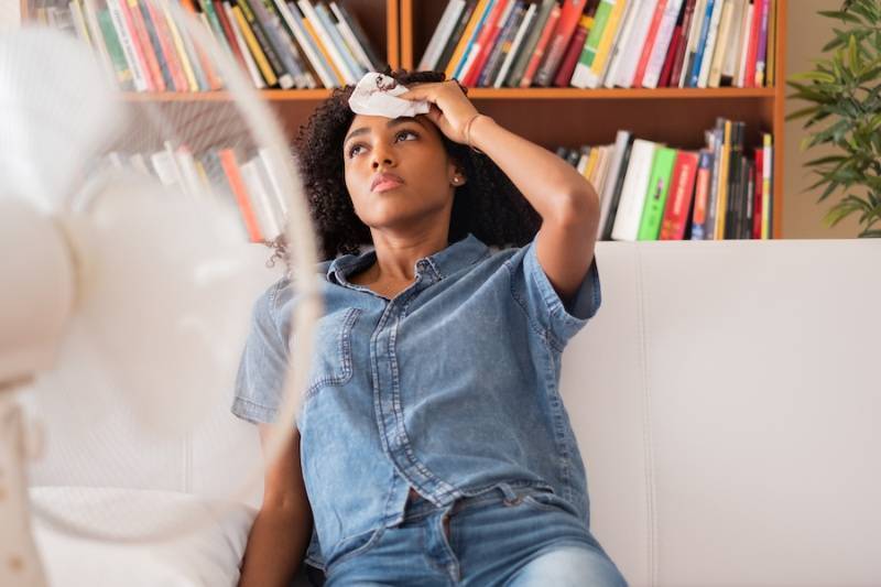 Homeowner experiencing heat wave while sitting on the couch.