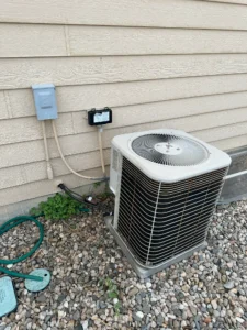 Outdoor AC condenser unit with disconnect box at a Loveland, CO home during a no-cooling diagnostic
