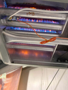 Furnace burners lit with blue flames after Balance Point Heating, Cooling & Plumbing replaced the gas valve in Loveland