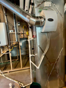 Aprilaire humidifier mounted on furnace ductwork inspected by Balance Point Heating, Cooling & Plumbing in Loveland