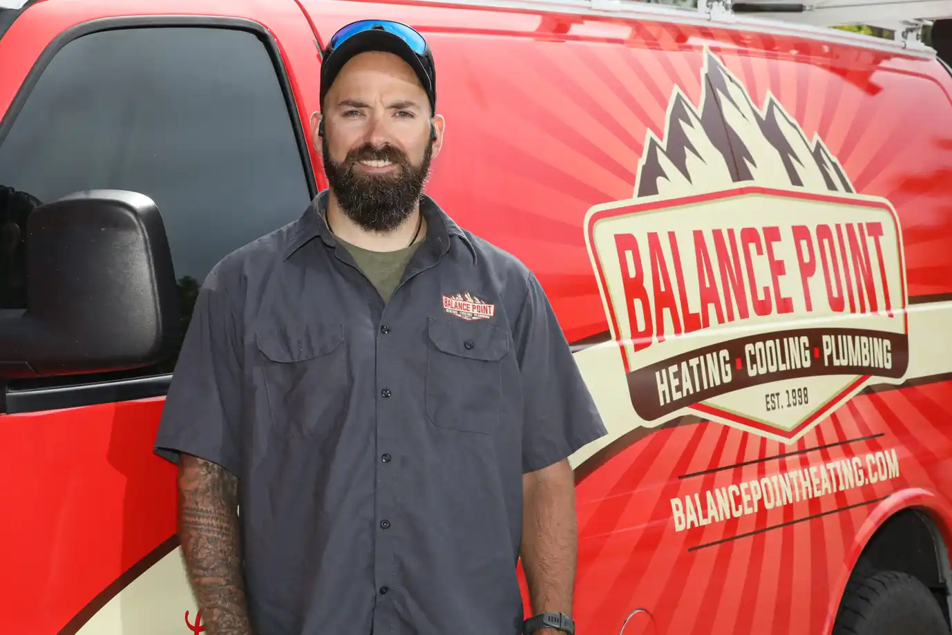 HVAC technician discussing maintenance with a homeowner