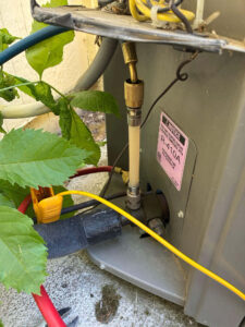 Fort Collins AC repair technician sealing a refrigerant leak and recharging an R-410A Lennox outdoor condenser unit