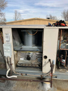 Rooftop package unit opened for a heat exchanger replacement by Balance Point Heating, Cooling & Plumbing in Fort Collins