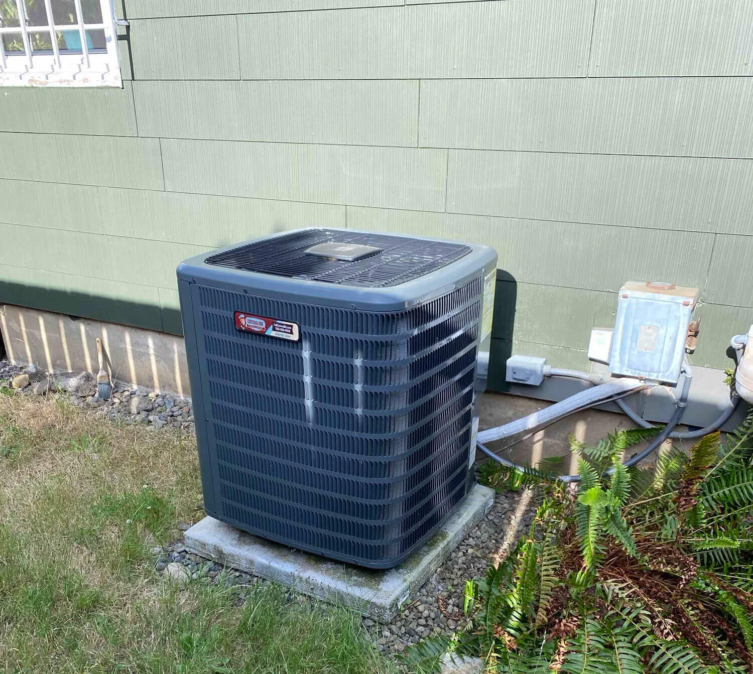 AC condenser unit outside a Northern Colorado home served by Balance Point Heating, Cooling & Plumbing