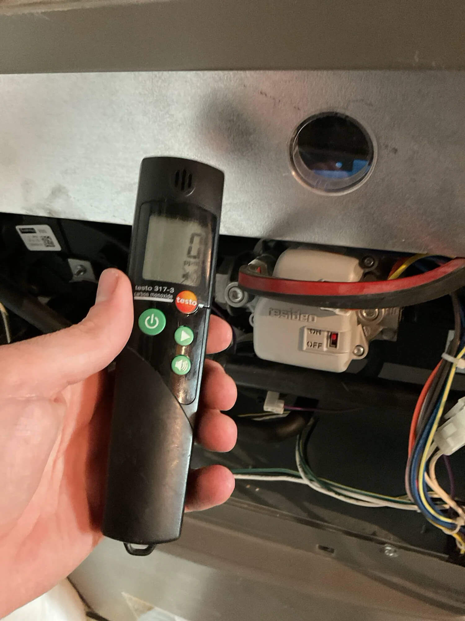 Technician using a carbon monoxide detector during a furnace inspection in a Fort Collins home served by Balance Point Heating, Cooling & Plumbing
