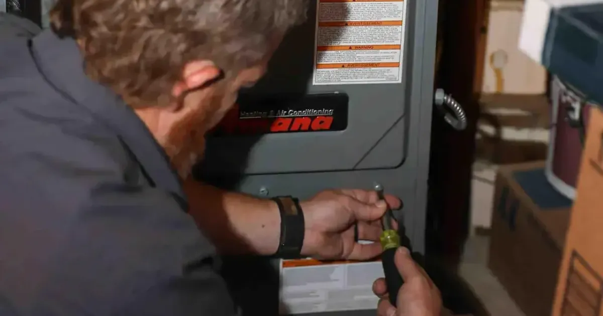 HVAC technician installing a furnace system in the basement of a residential house in Fort Collins.