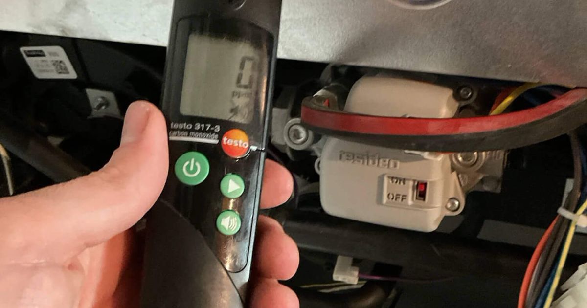 Technician using a carbon monoxide detector during a furnace inspection in a Fort Collins home served by Balance Point Heating, Cooling & Plumbing