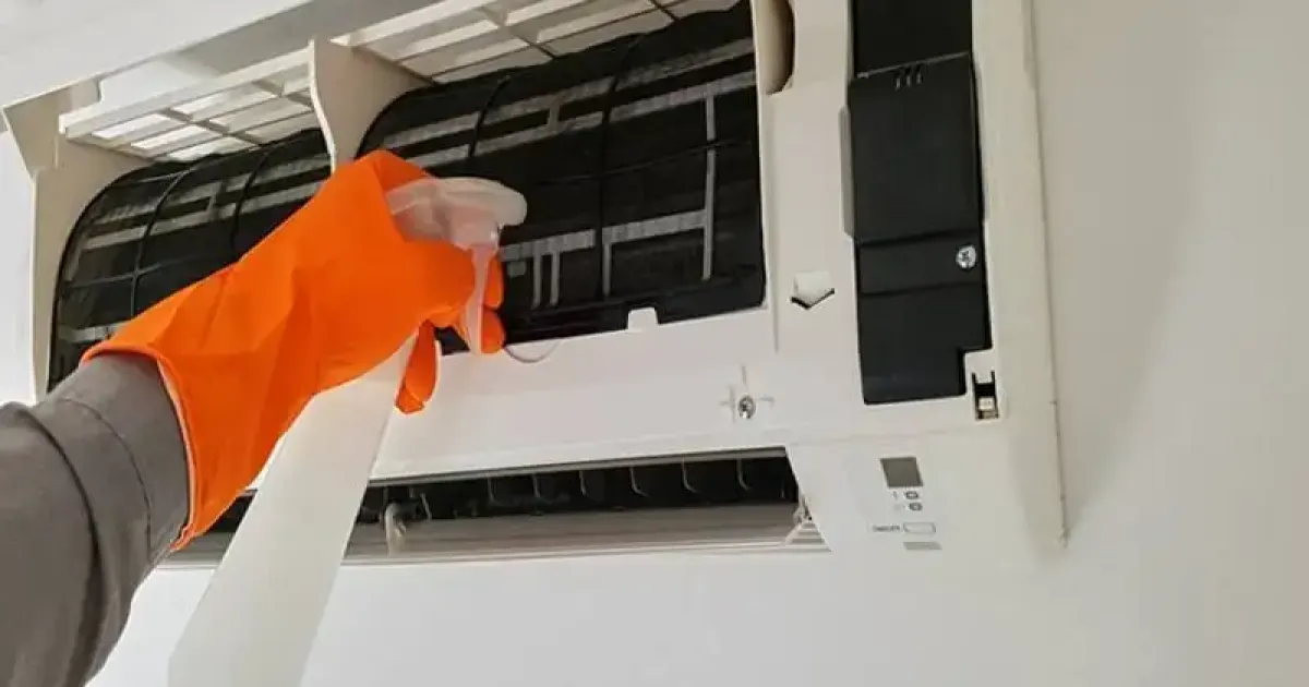 HVAC technician performing maintenance on a ductless system.