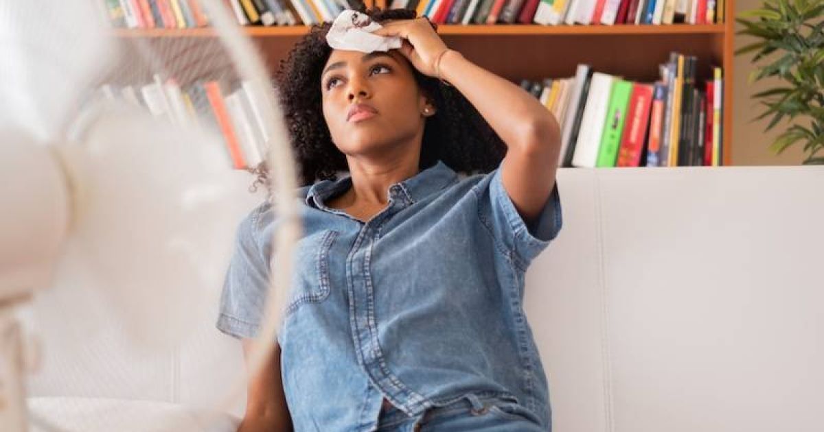 Homeowner experiencing heat wave while sitting on the couch.