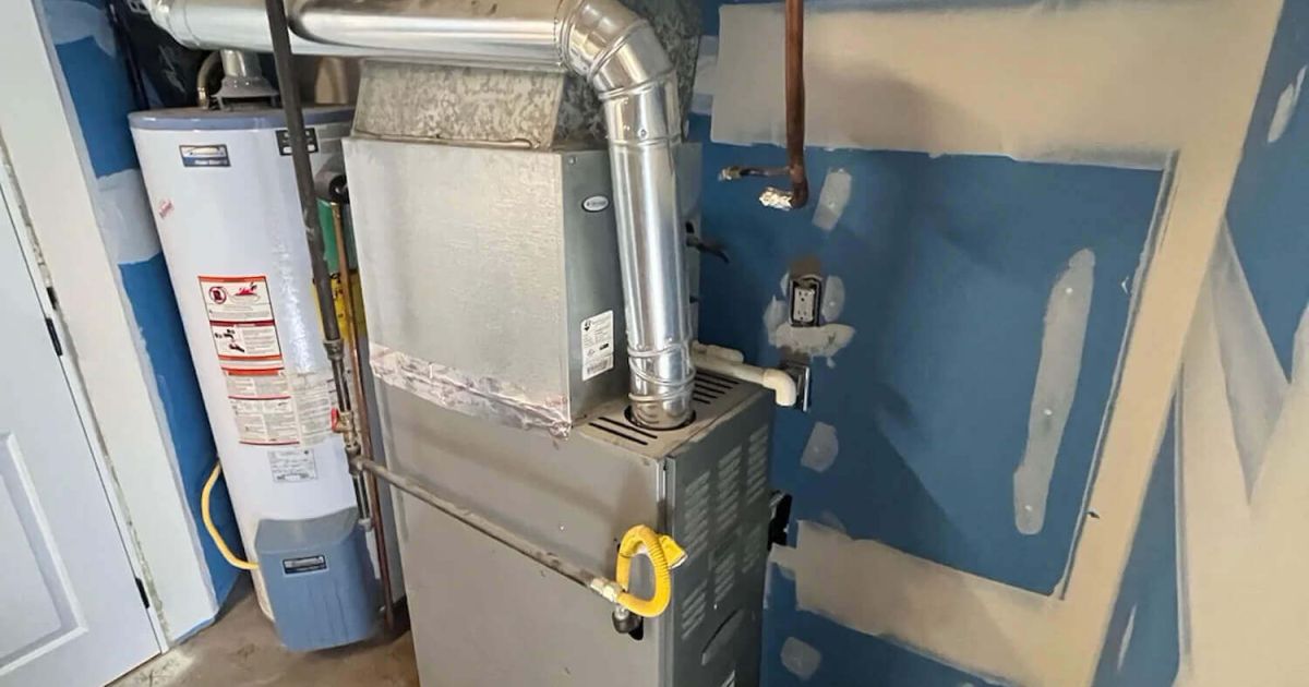 Gas furnace and water heater in a Fort Collins home utility room served by Balance Point Heating, Cooling & Plumbing